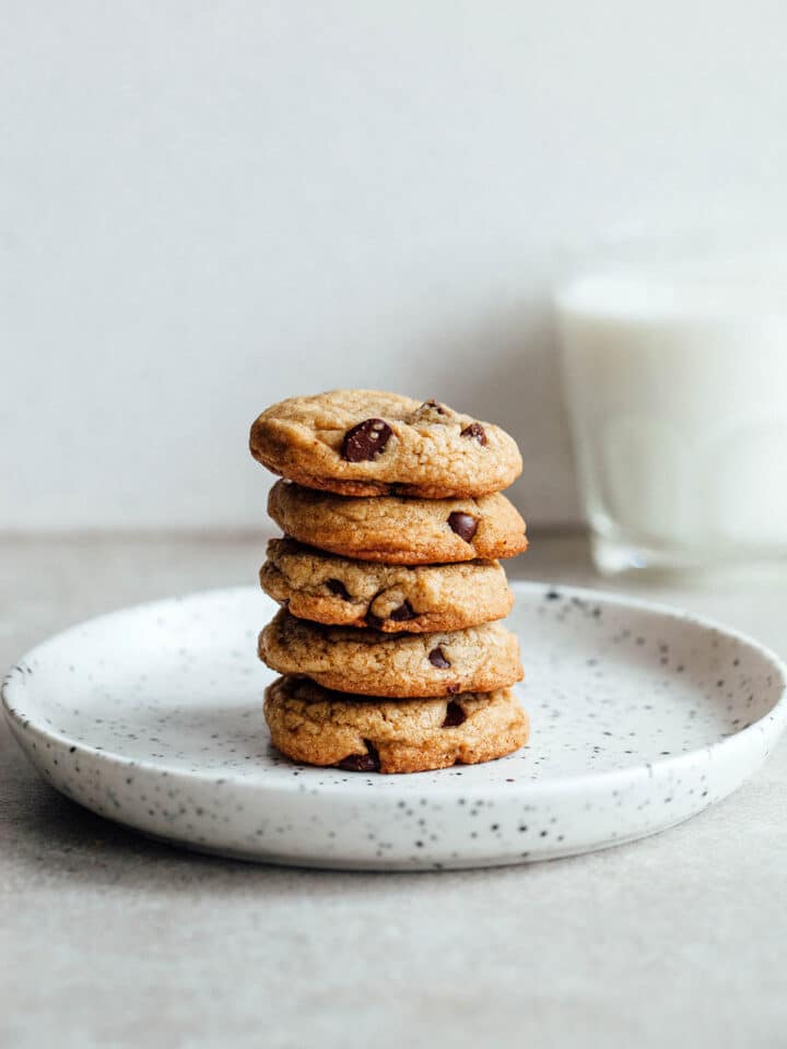 A stack of brown butter chocolate chip cookies on a plate.
