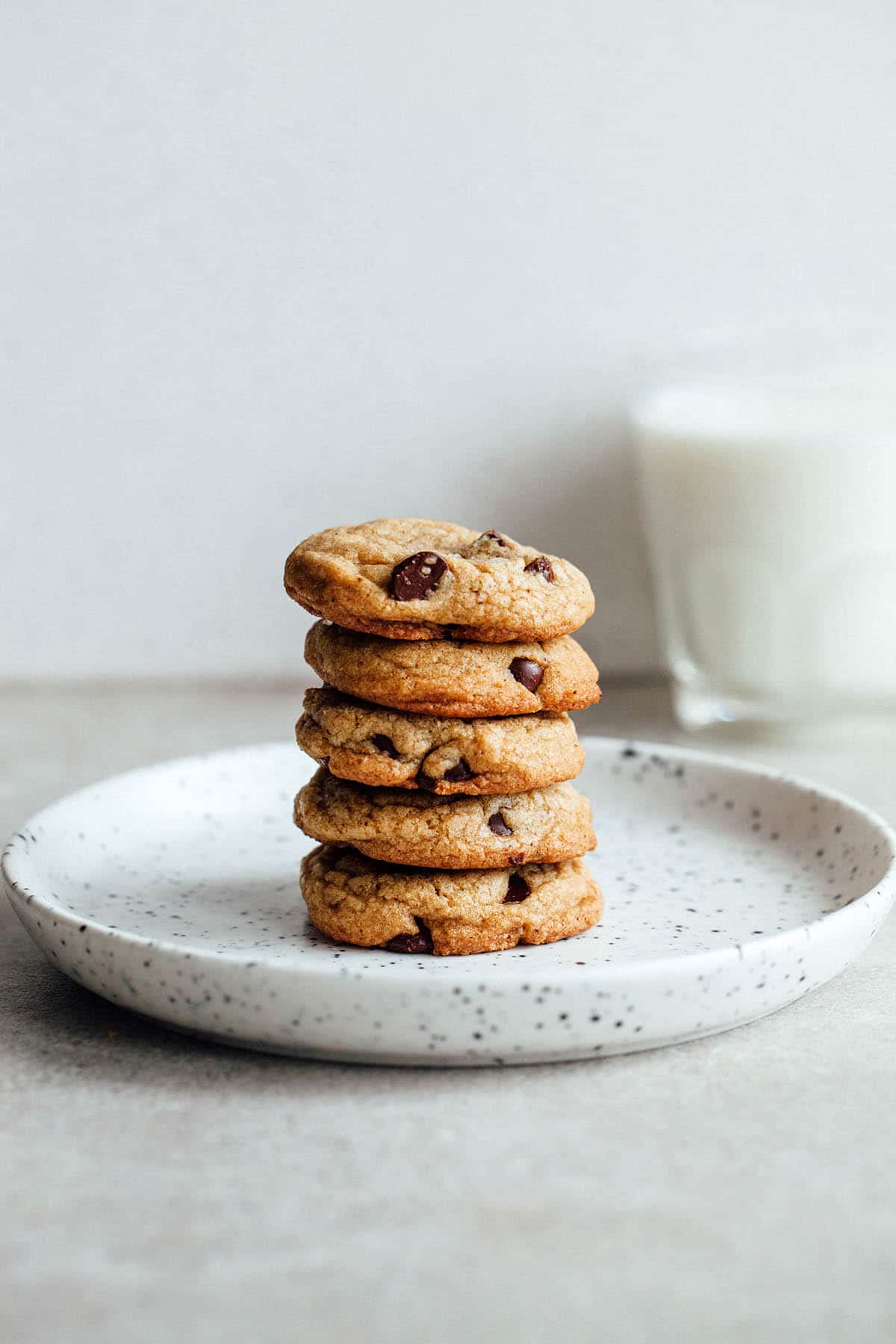 A stack of brown butter chocolate chip cookies on a plate.