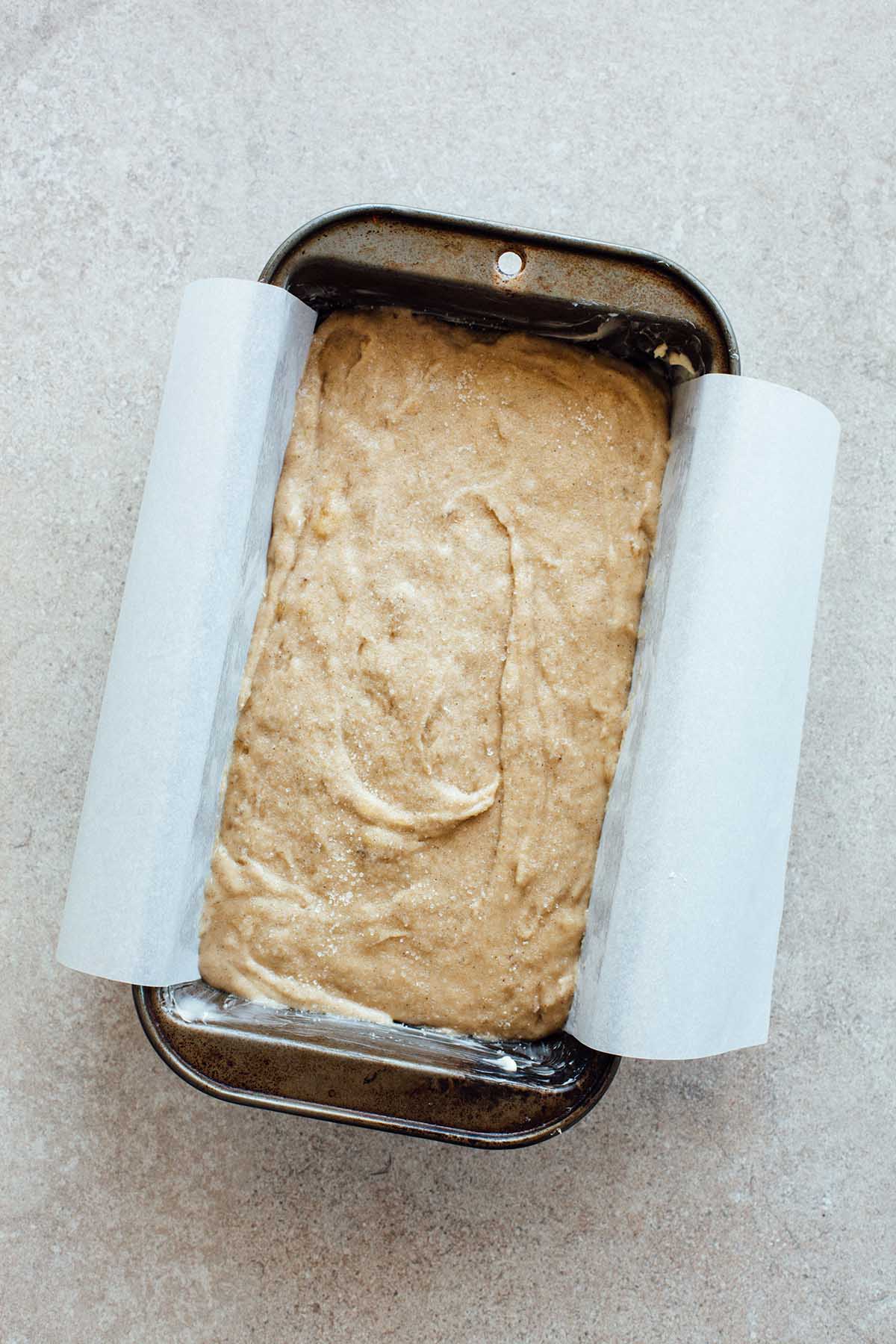 Unbaked banana bread batter in a loaf tin.