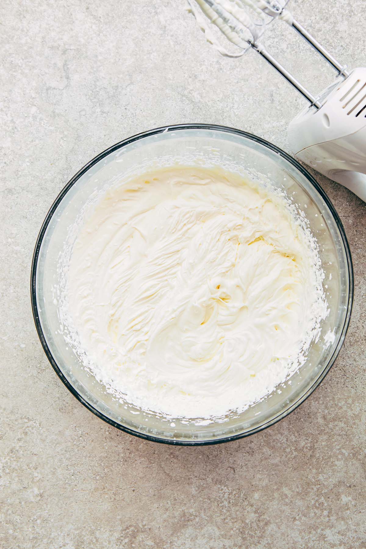A large glass bowl of whipped cream.