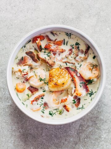 A bowl of Nova Scotia seafood chowder topped with a pan seared scallop.