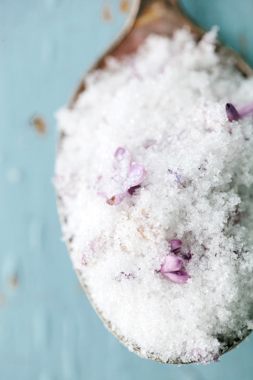 CLose up of lilac sugar on a spoon.