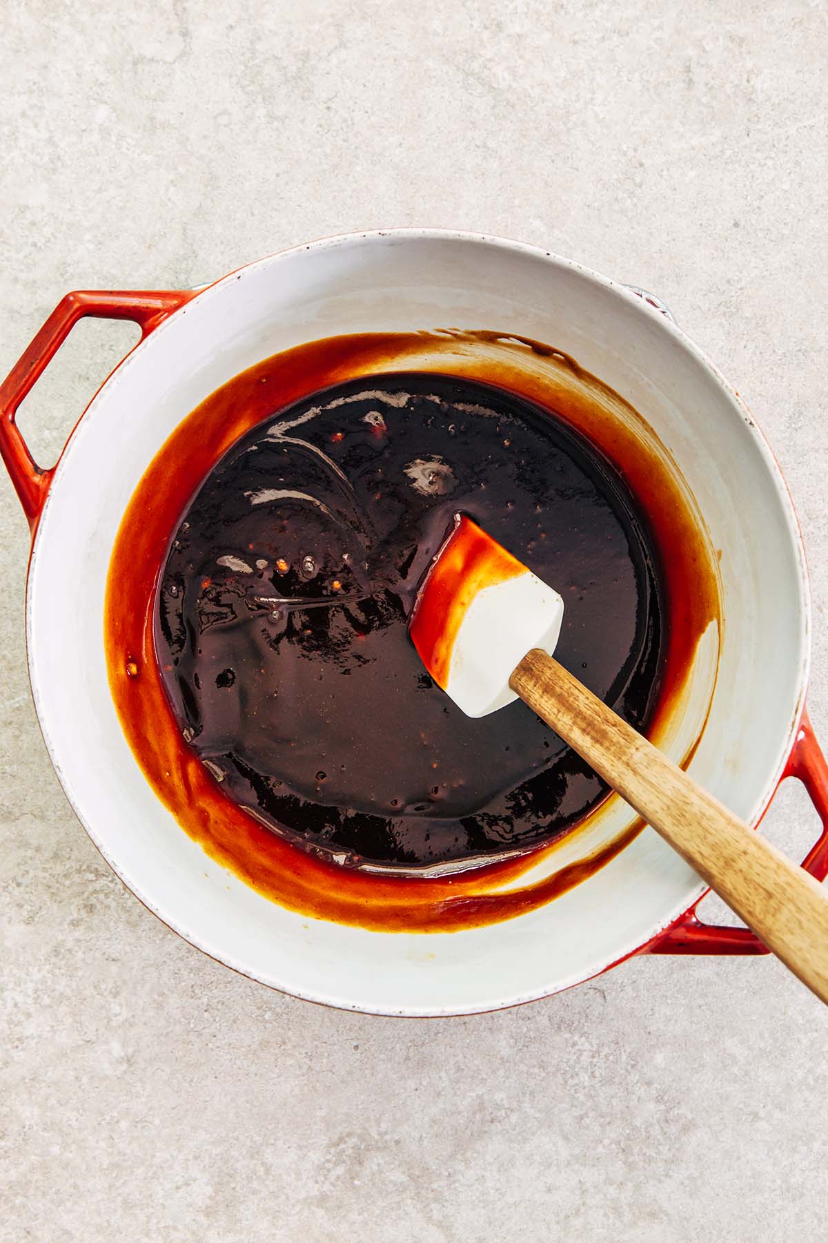 Molasses mixture stirred together in a pot.