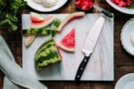 Sliced watermelon on a marble cutting board.