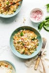 A bowl of charred corn couscous salad with feta and basil.