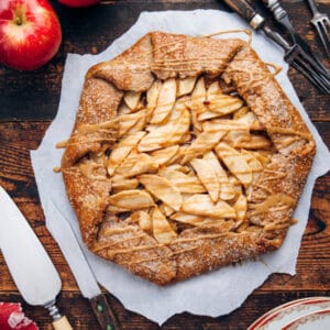 Overhead of an apple galette on a wooden table.