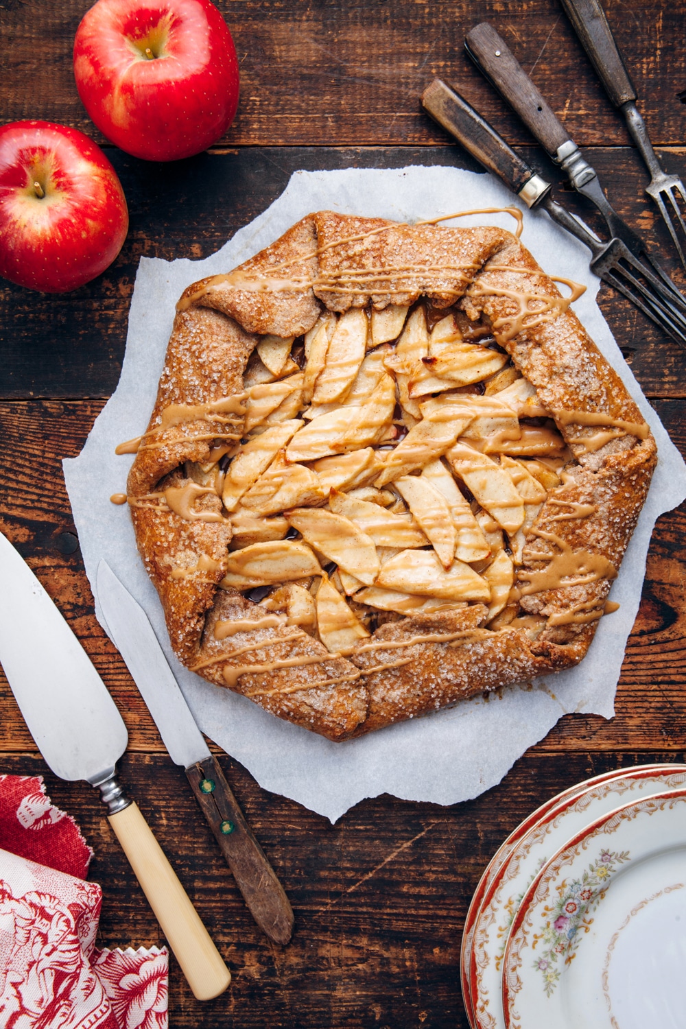 Spicy apple galette with coffee glaze on a wooden table.