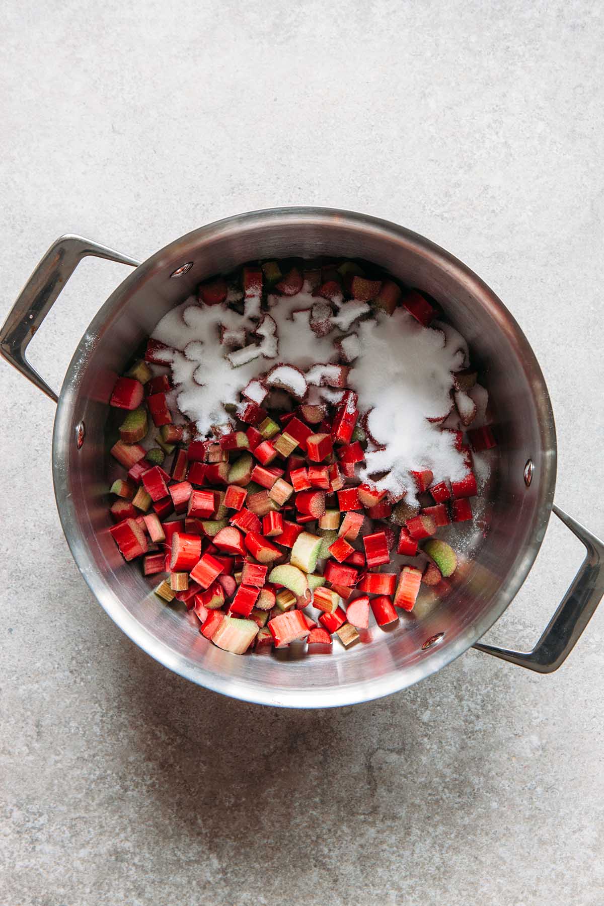 Chopped rhubarb and sugar in a pot.