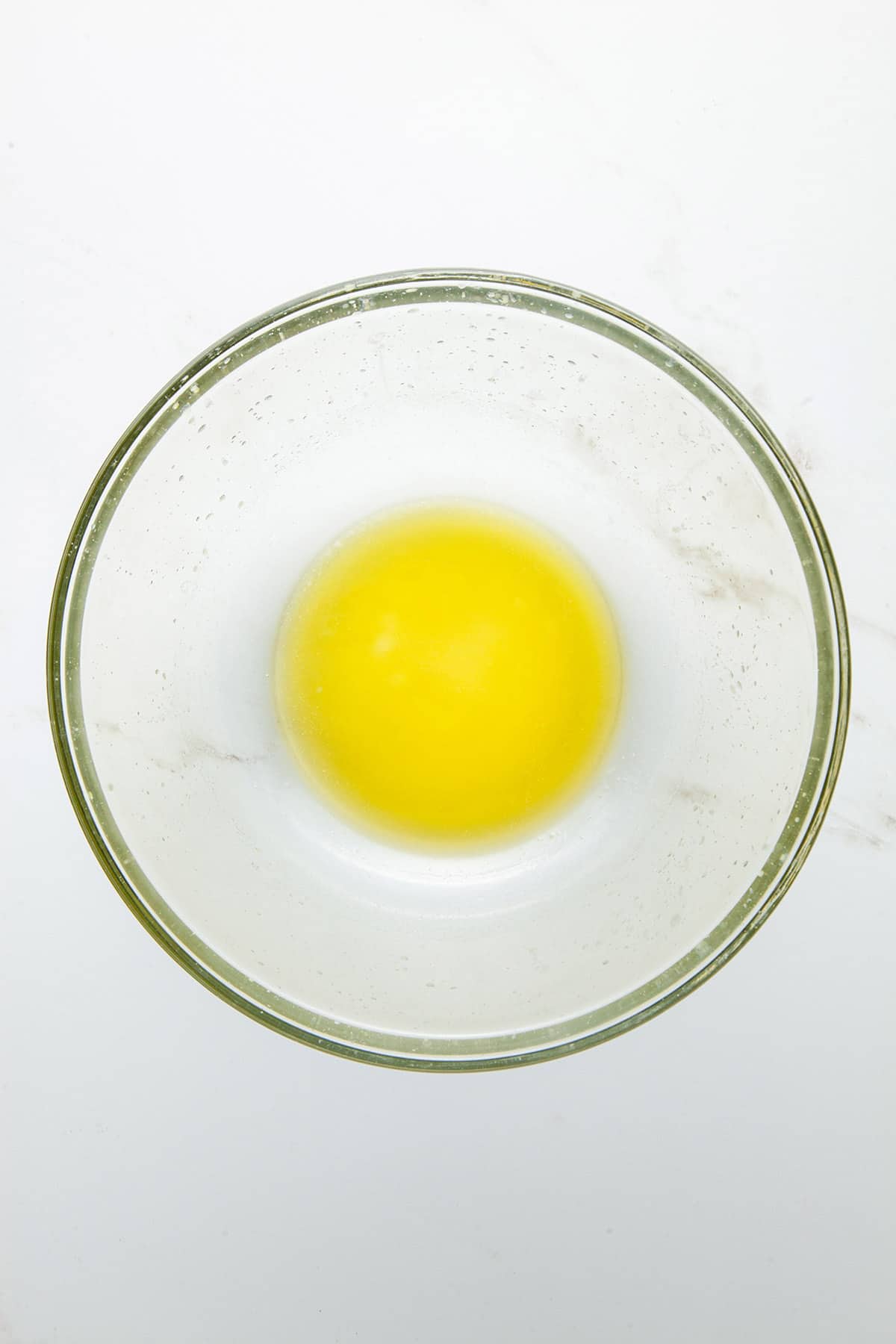 A glass bowl of melted butter.