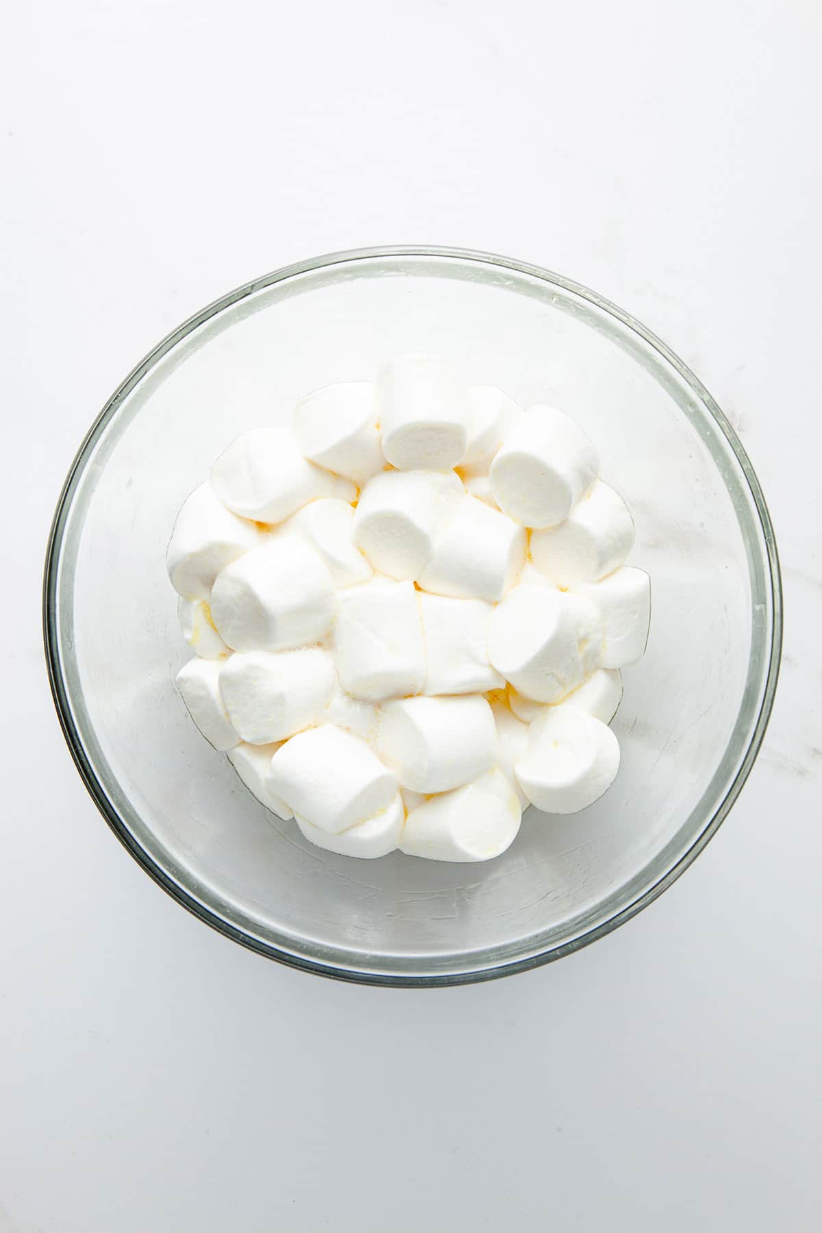 A glass bowl of half melted marshmallows.