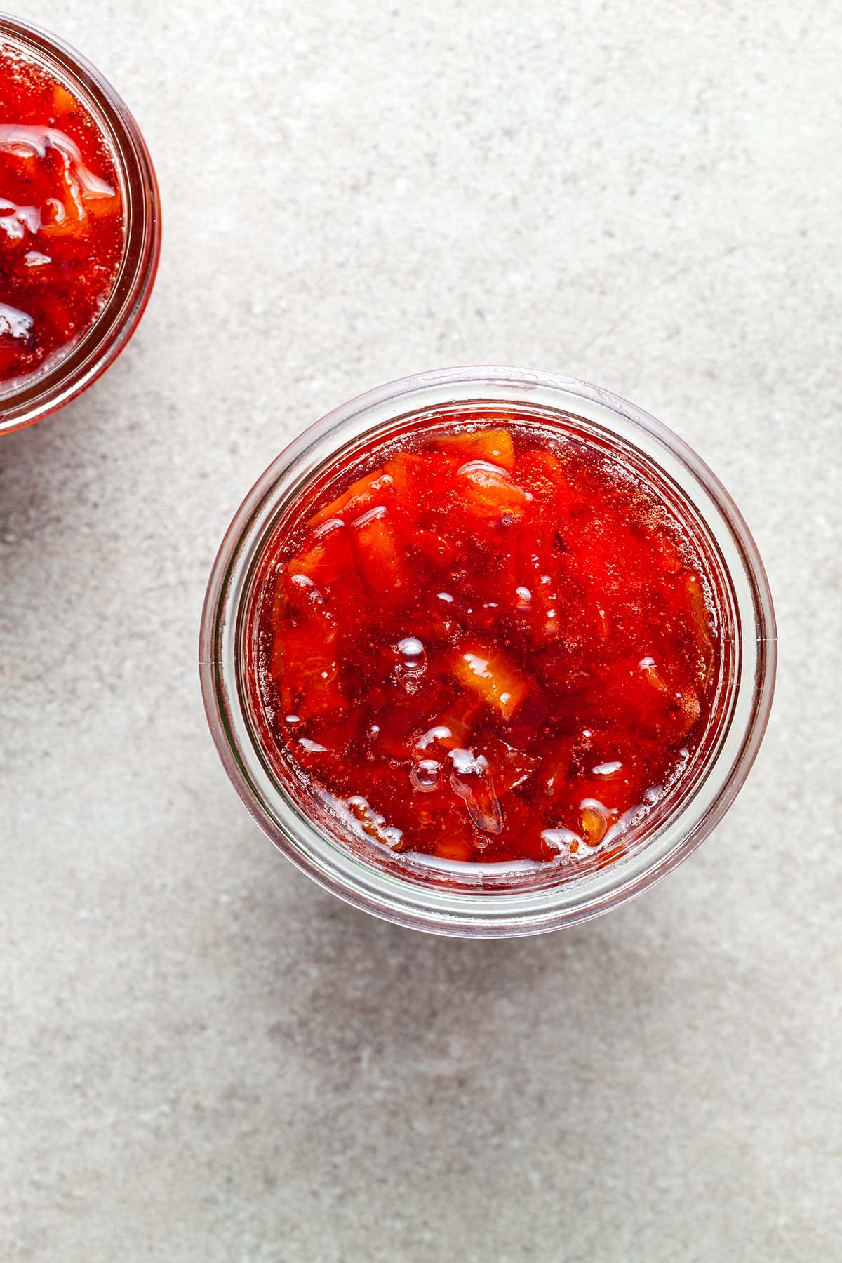 Two jars of small batch peach jam.