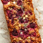 Close up of a raspberry and white chocolate loaf cake.