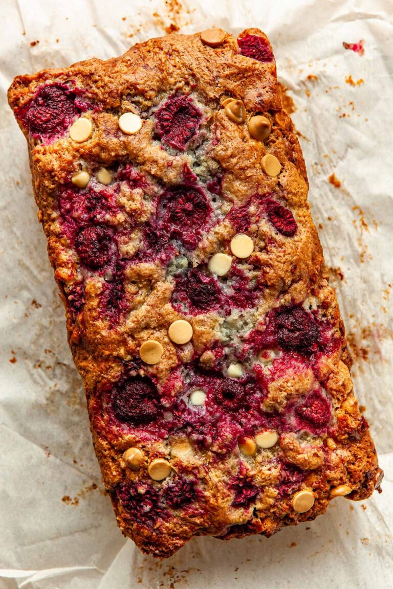 Close up of a raspberry and white chocolate loaf cake.
