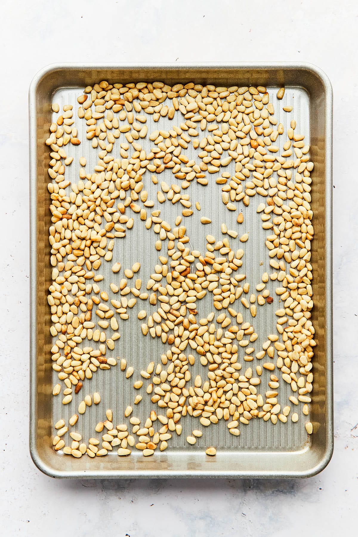 A tray of lightly toasted pine nuts.