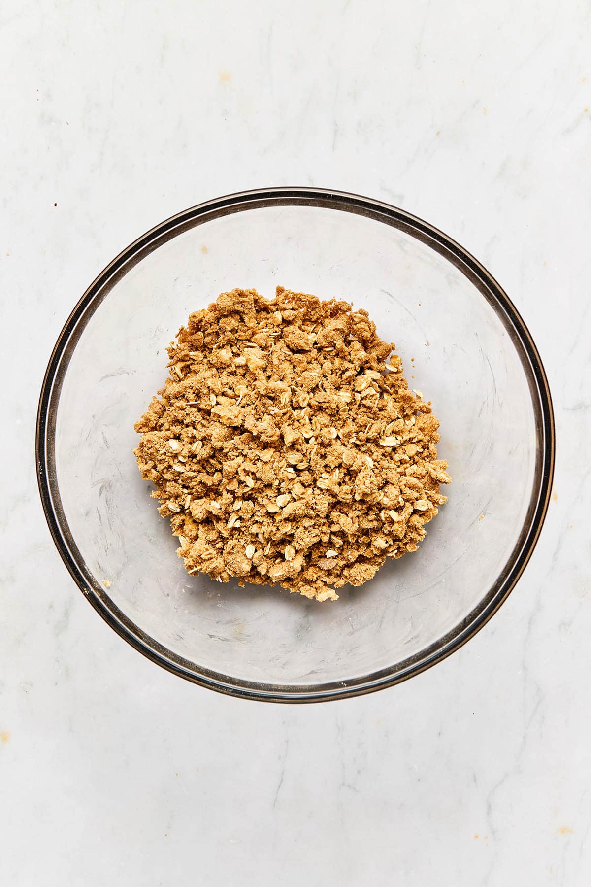 Mixed oat topping in a glass bowl.