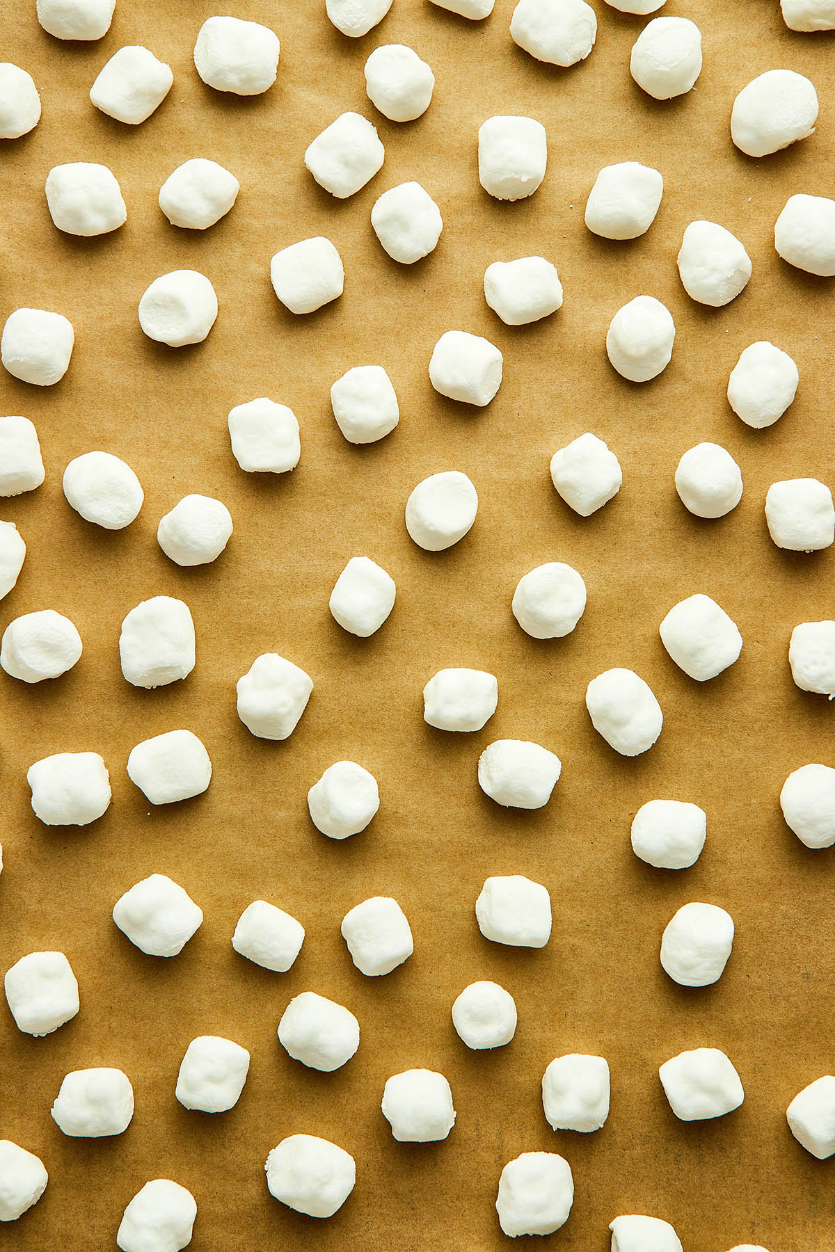 Close up overhead image of dried marshmallows on a baking sheet.