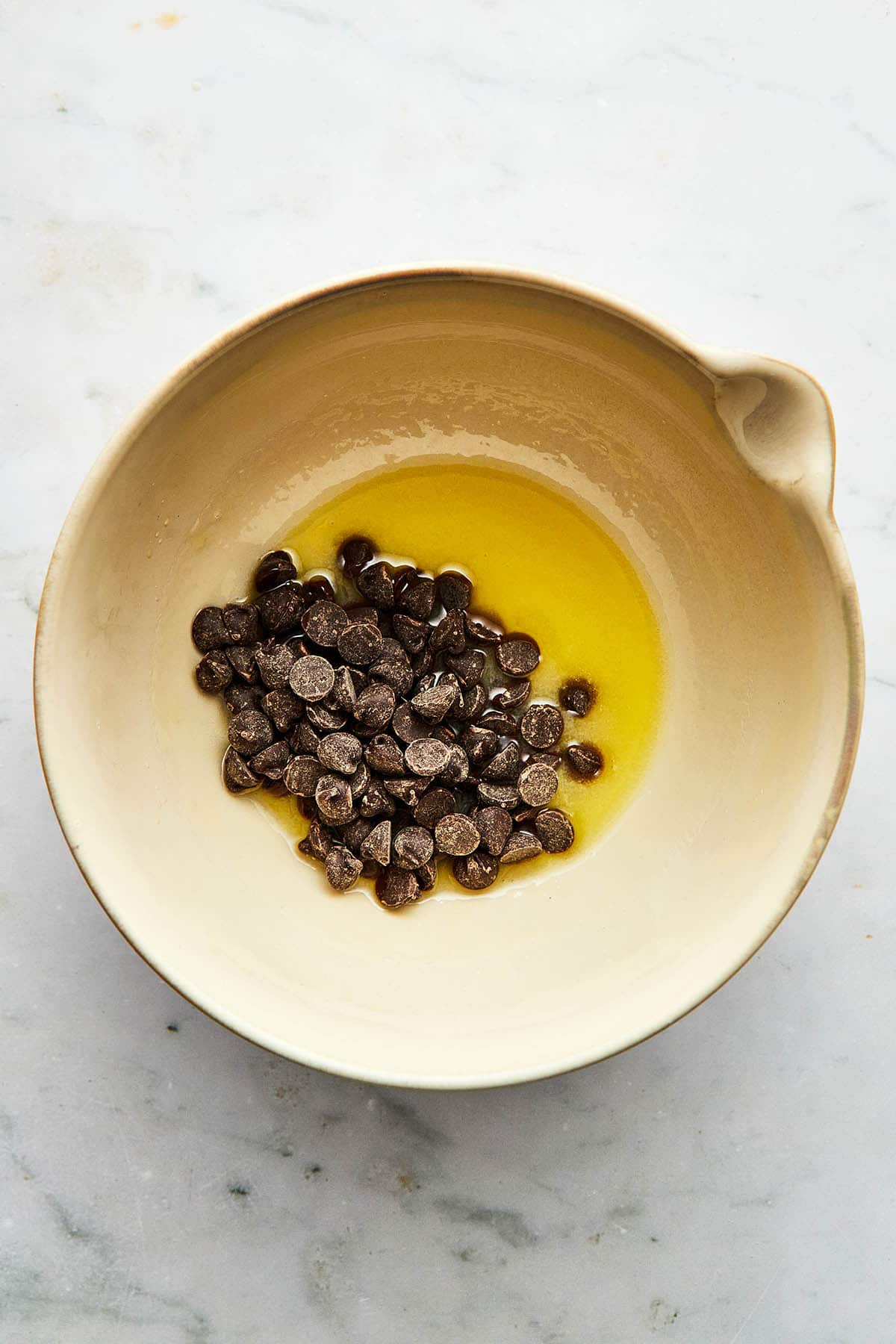 Chocolate chips and melted butter, not stirred together, in a small mixing bowl.