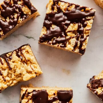 Overhead image of peanut butter Rice Krispie treats on a marble surface.