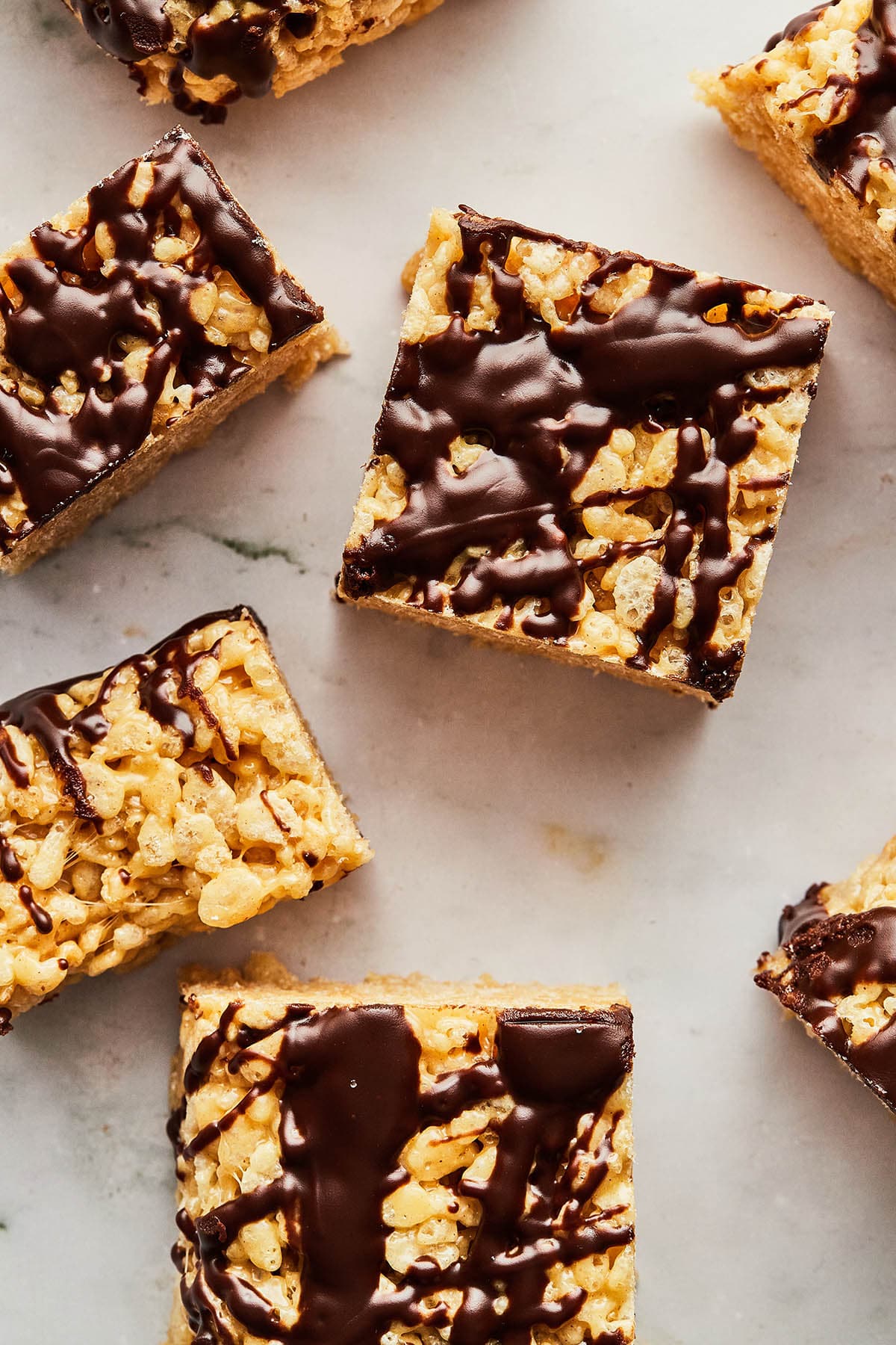 Overhead image of peanut butter Rice Krispie treats on a marble surface.