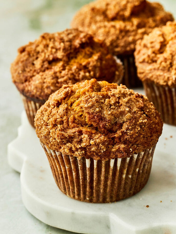 Pumpkin banana muffins on a marble serving board.