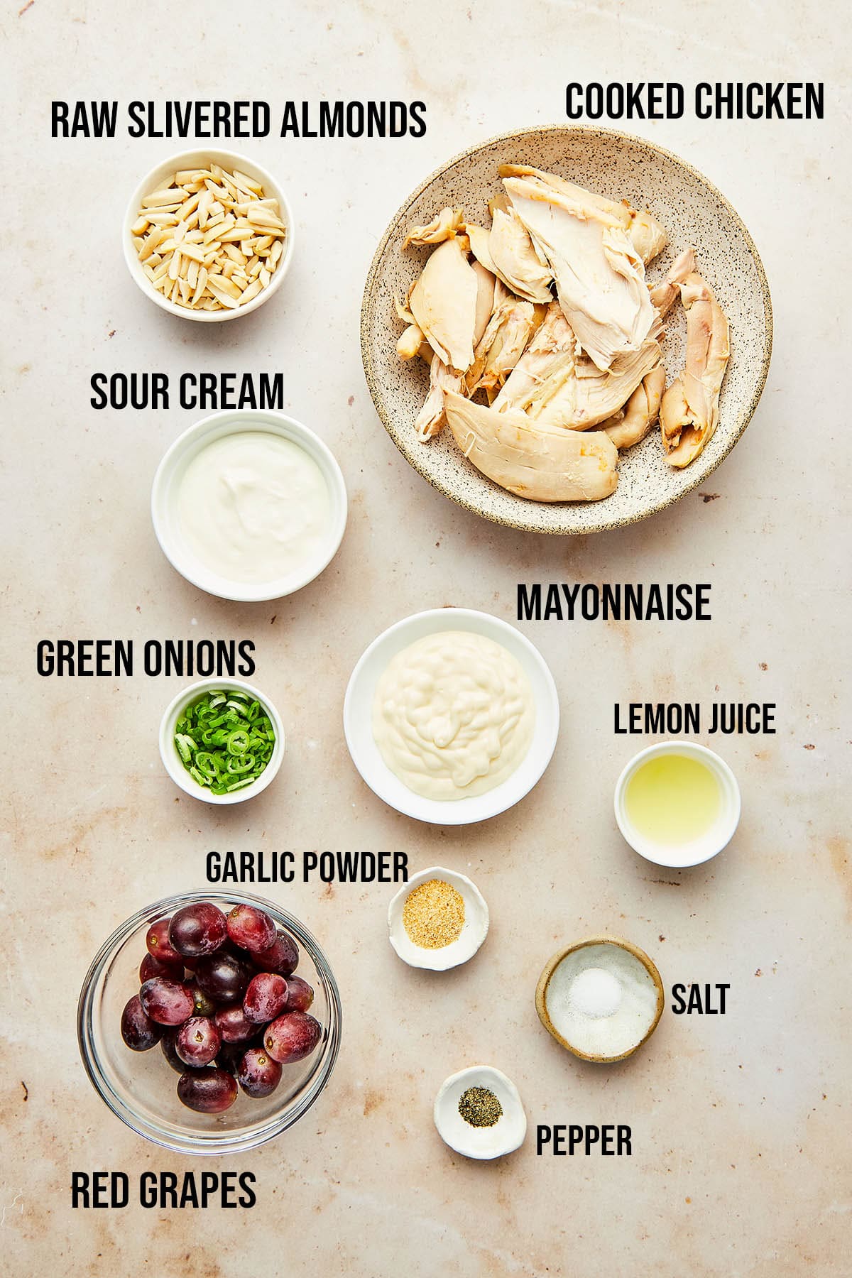 Ingredients to make chicken salad with grapes and almonds.