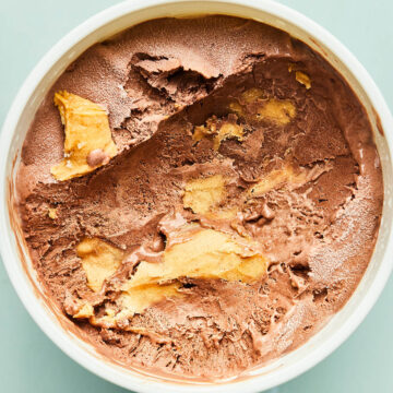 The inside of a scooped tub of chocolate peanut butter ice cream.