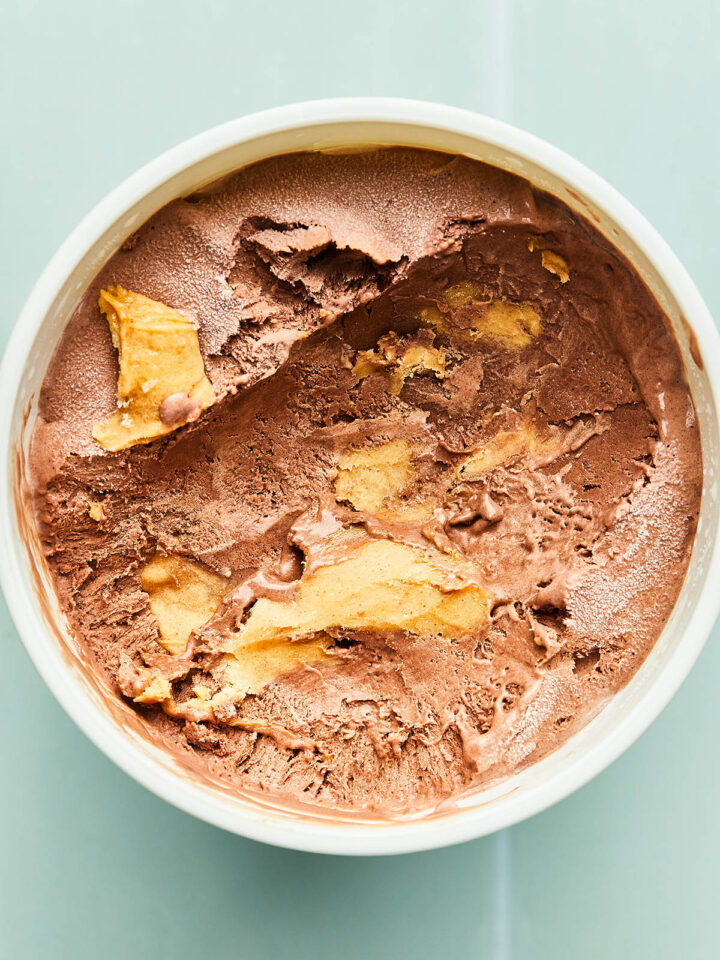 The inside of a scooped tub of chocolate peanut butter ice cream.