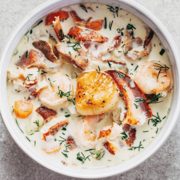 A bowl of Nova Scotia seafood chowder topped with a pan seared scallop.
