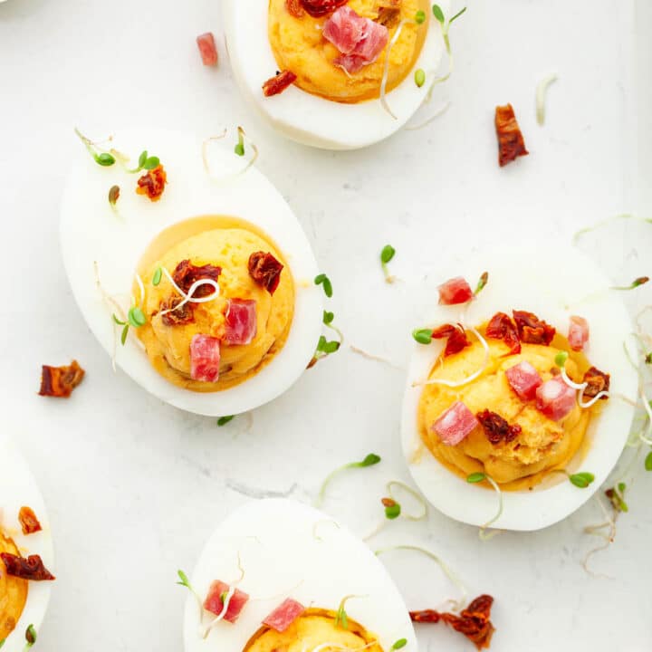 Sriracha deviled eggs topped with spring micro greens.