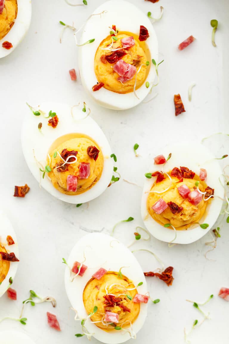 Sriracha deviled eggs topped with spring micro greens.