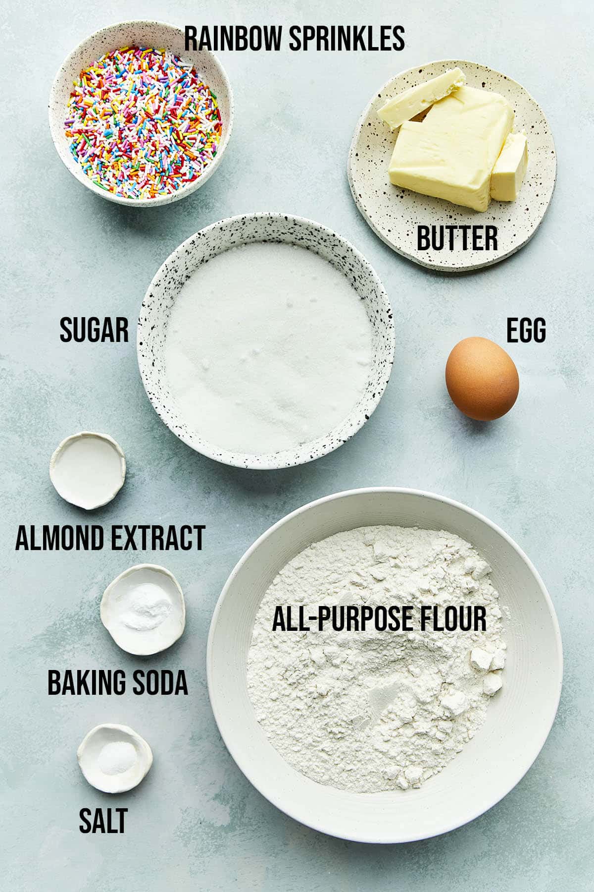 Ingredients to make sugar cookies with sprinkles.