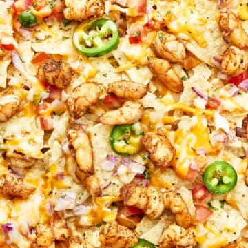 Shrimp nachos with jalapeños already baked with melted cheese.