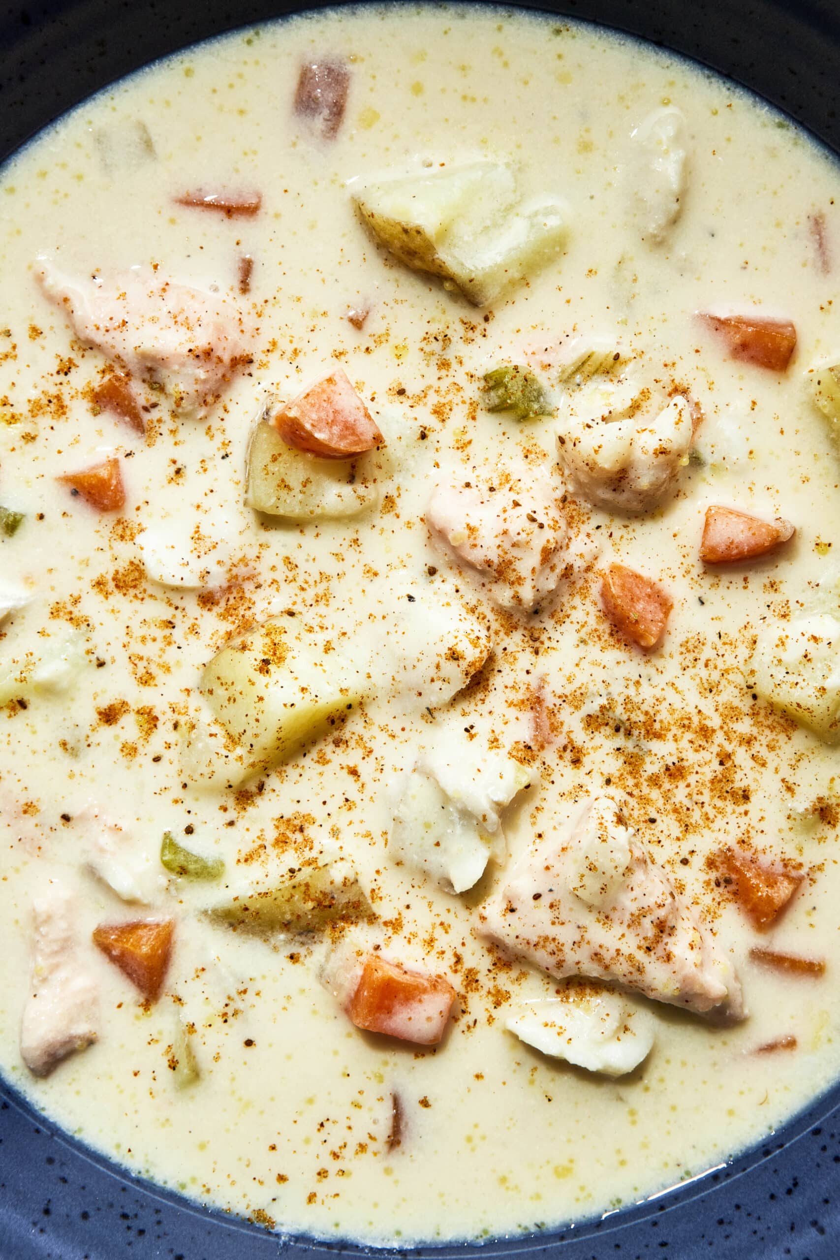 A bowl of East Coast fish chowder are sprinkled with Olde Bay.