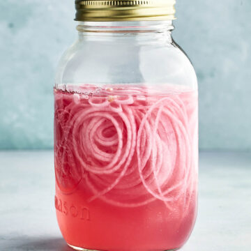 A jar of pink pickled onions.