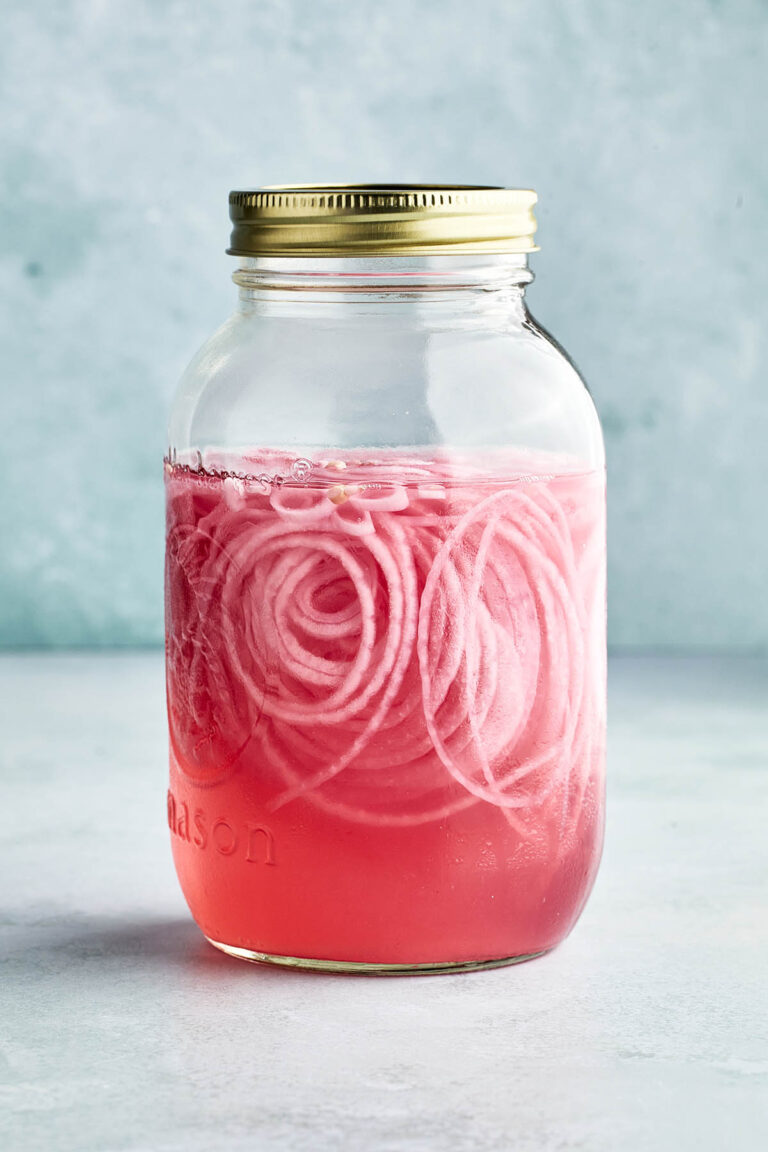 A jar of pink pickled onions.