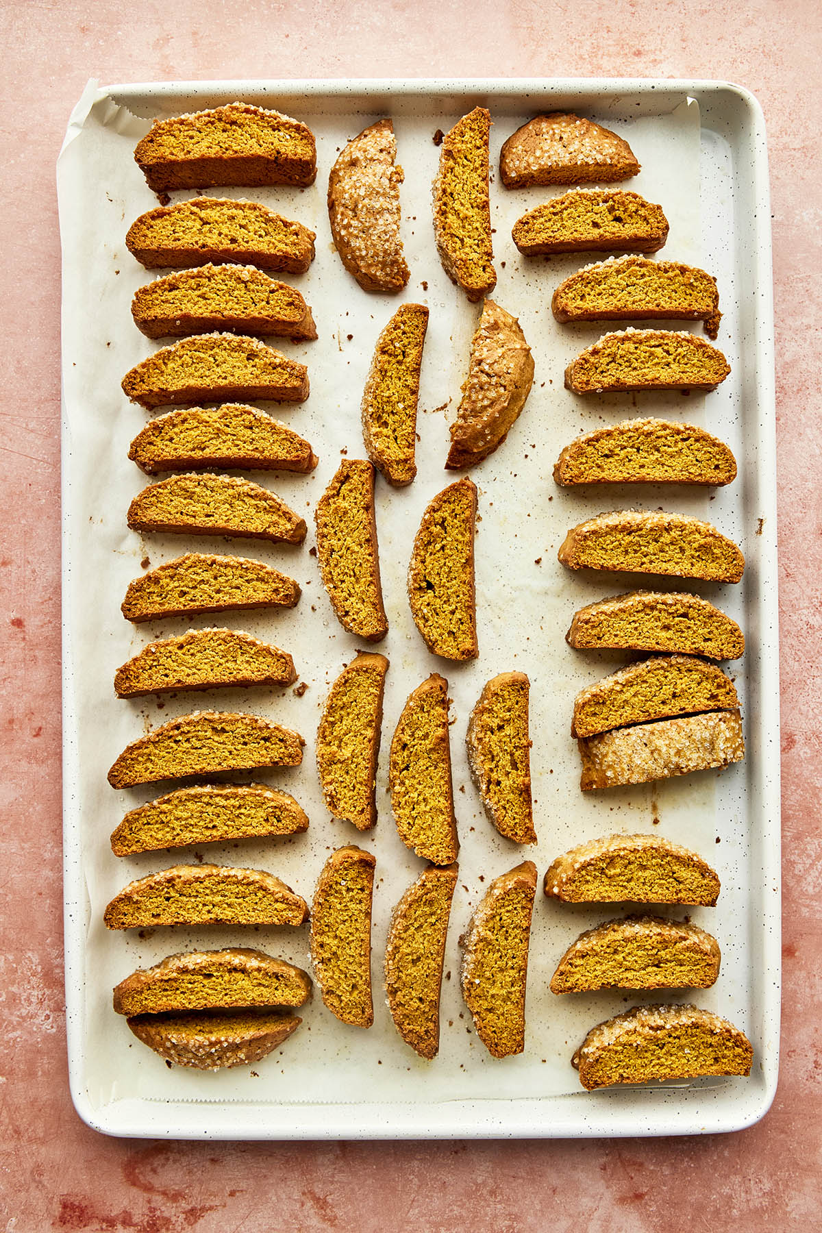 Pumpkin biscotti fully baked on a baking tray.