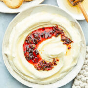A bowl of whipped feta with honey topped with chili crisp.