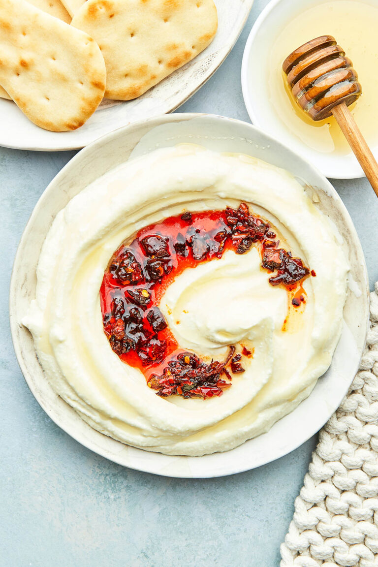 A bowl of whipped feta with honey topped with chili crisp.