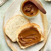 A platter of homemade porridge bread slathered with molasses butter.