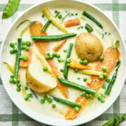 A bowl of Nova Scotia Hodge Podge on a green and white striped tablecloth