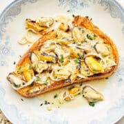 Mussels in lemon cream broth spooned over crisp sourdough toast.