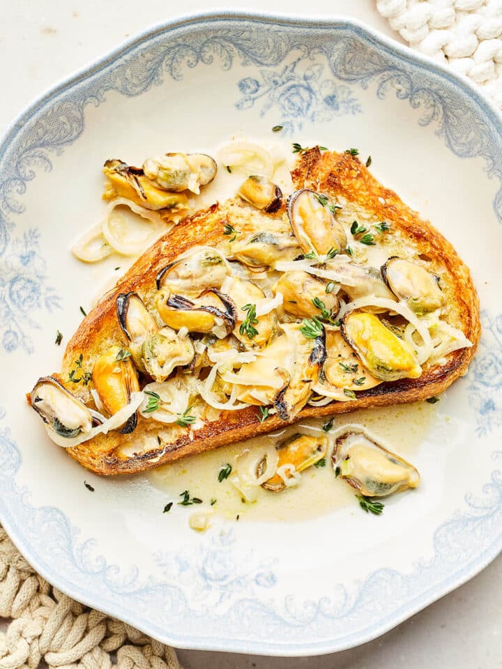 Mussels in lemon cream broth spooned over crisp sourdough toast.