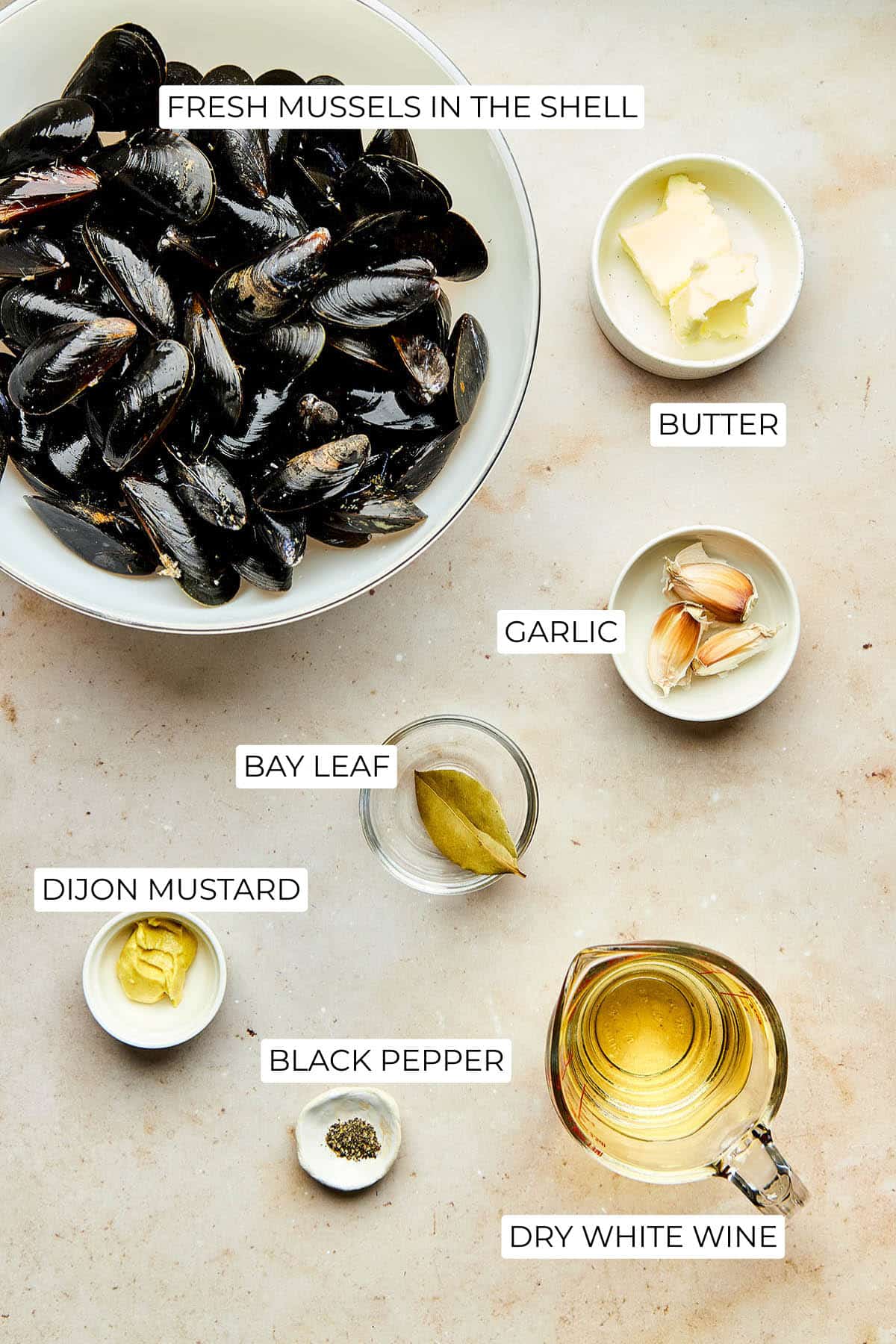 Ingredients to make mussels in white wine sauce.