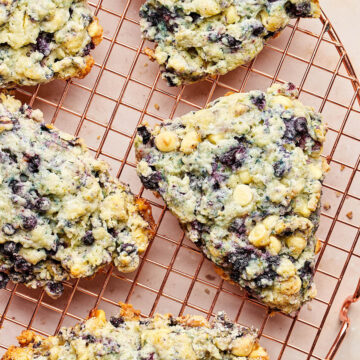 Blueberry white chocolate scones on a cooling rack.