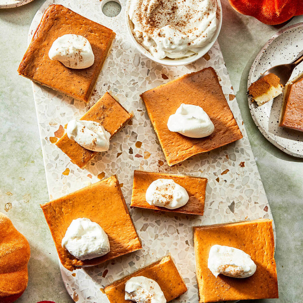 A platter of pumpkin pie bars on a Thanksgiving holiday table.