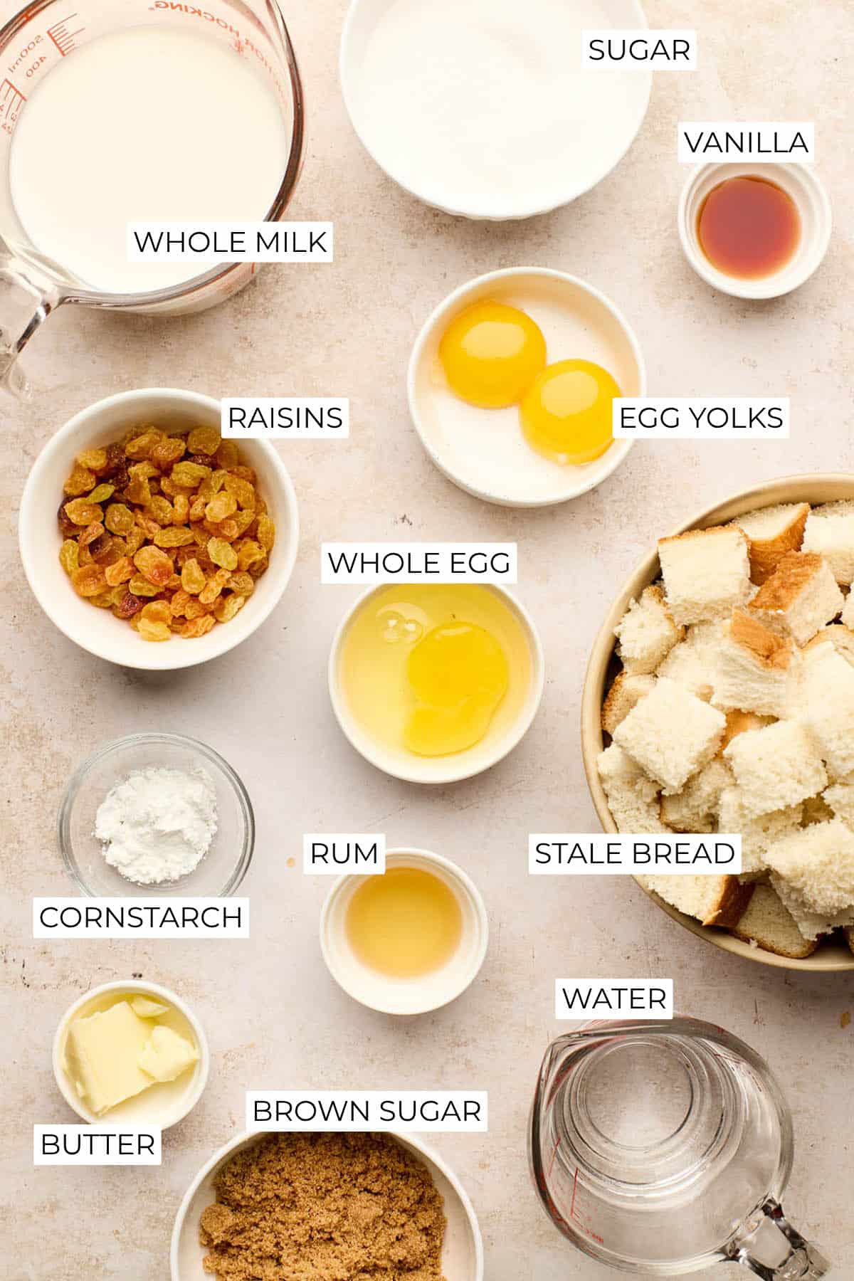 Milk, sugar, eggs, raisins, cubed white bread, butter, brown sugar, cornstarch, rum, vanilla, and water to make old-fashioned bread pudding with rum sauce.